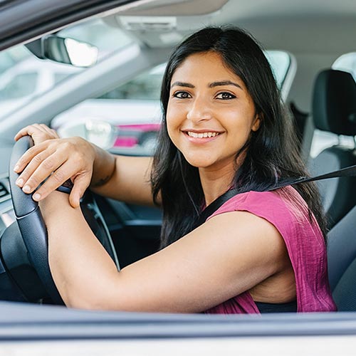 Young woman behind the wheel of a car