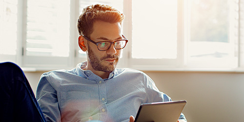 Man reading from a tablet