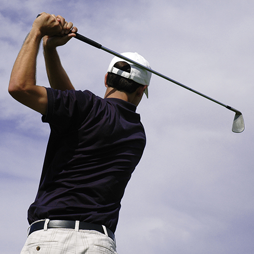 A golfer holding his finish after a great shot.