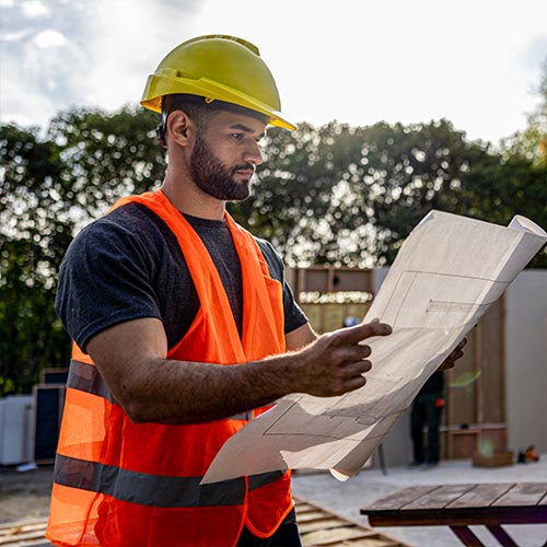 Construction worker looking at plans
