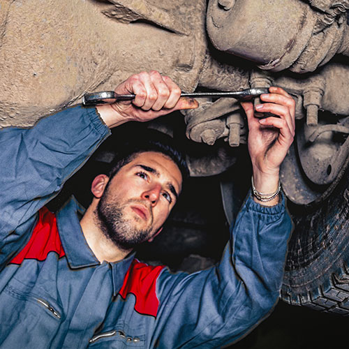 A worker repairs a car