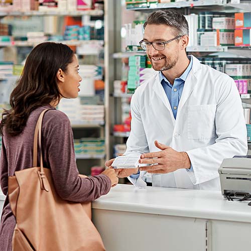 A pharmacist talks to a customer
