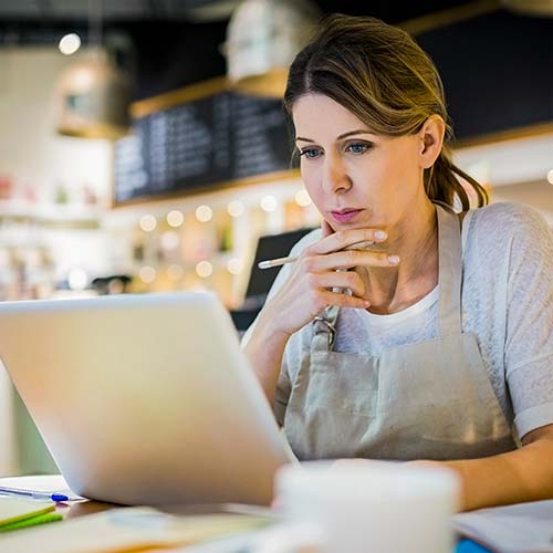 A business owner looks at a computer