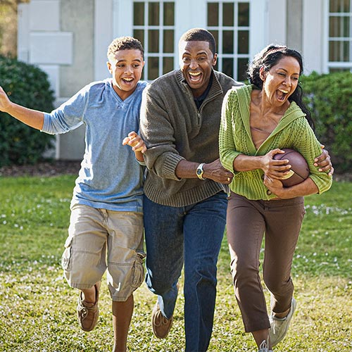 A family enjoys a game of football at their home