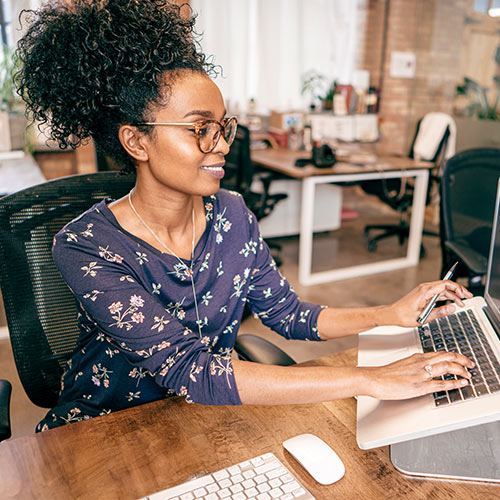 A business owner looks at a computer