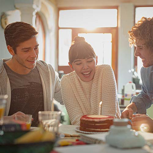 A group of friends enjoy a cake