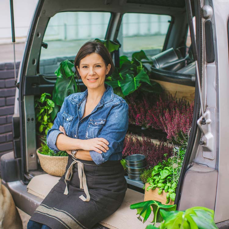 A florist sits in a commercial auto vehicle
