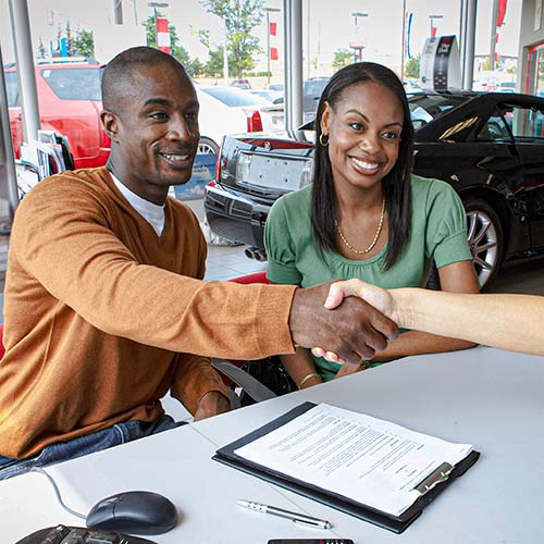 A couple signs an auto lease