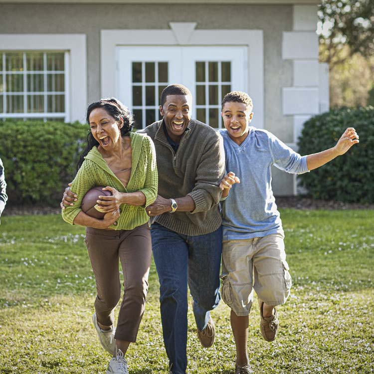 A family enjoys a game of football at their home